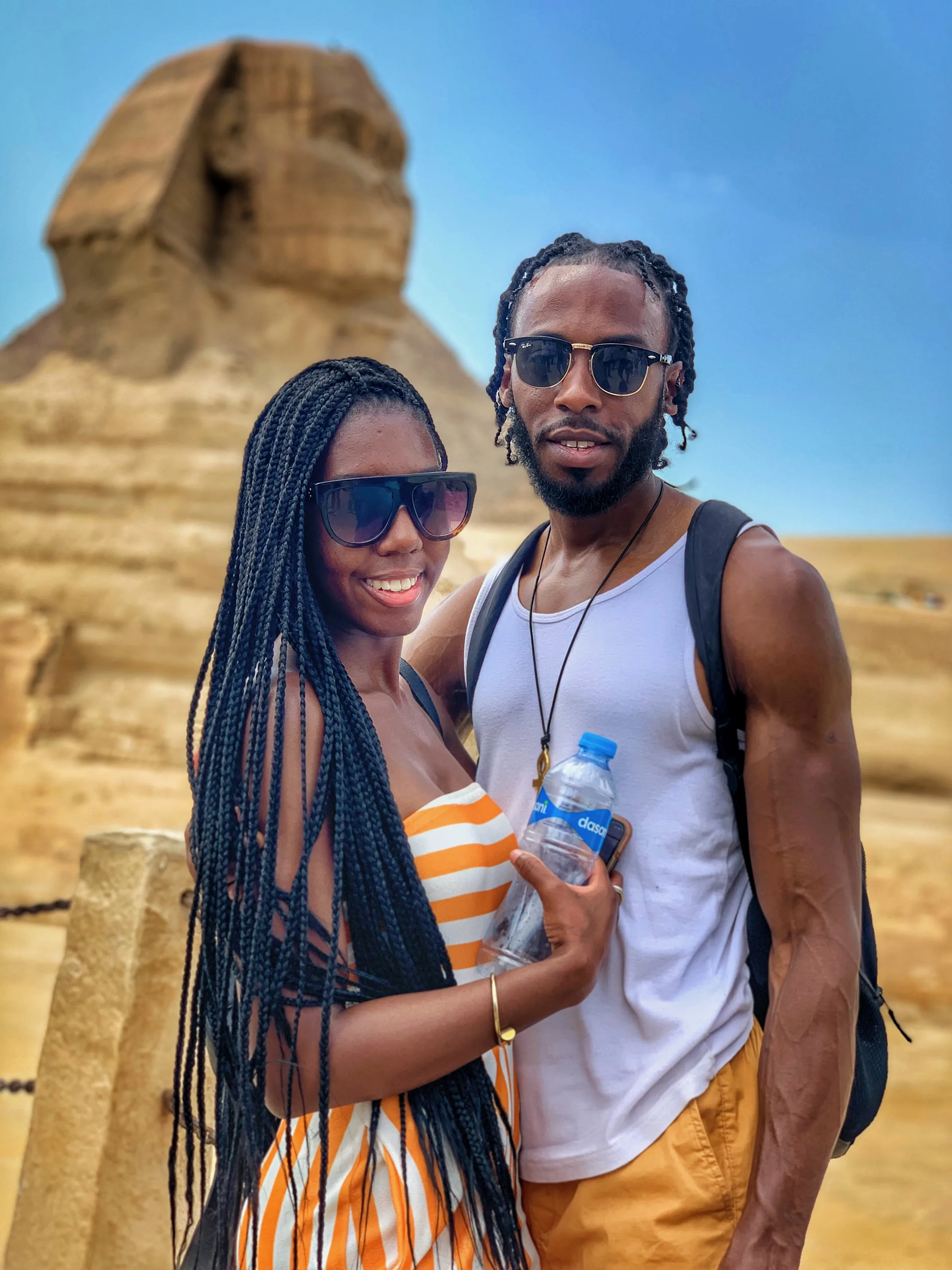 Two people standing together with the Sphinx behind them.