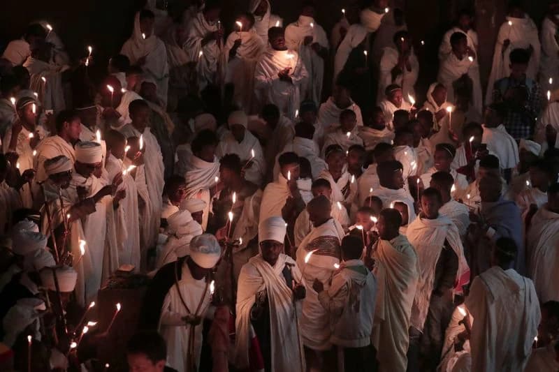 Crowds gathered in white at a historic site
