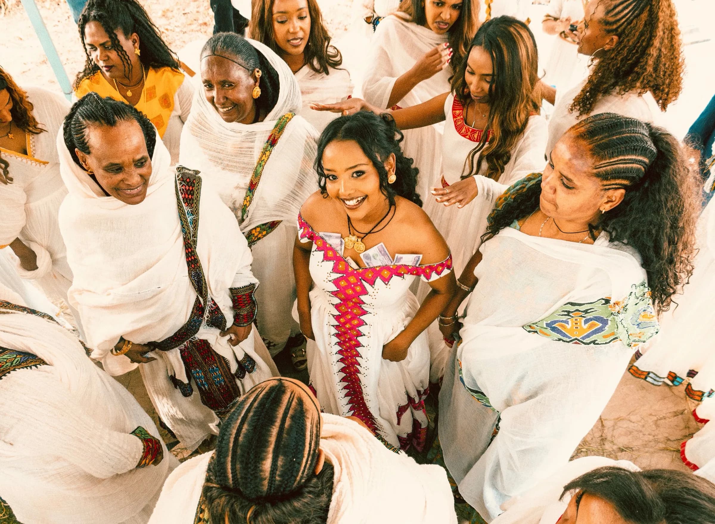 Group in white clothing gathered together in celebration