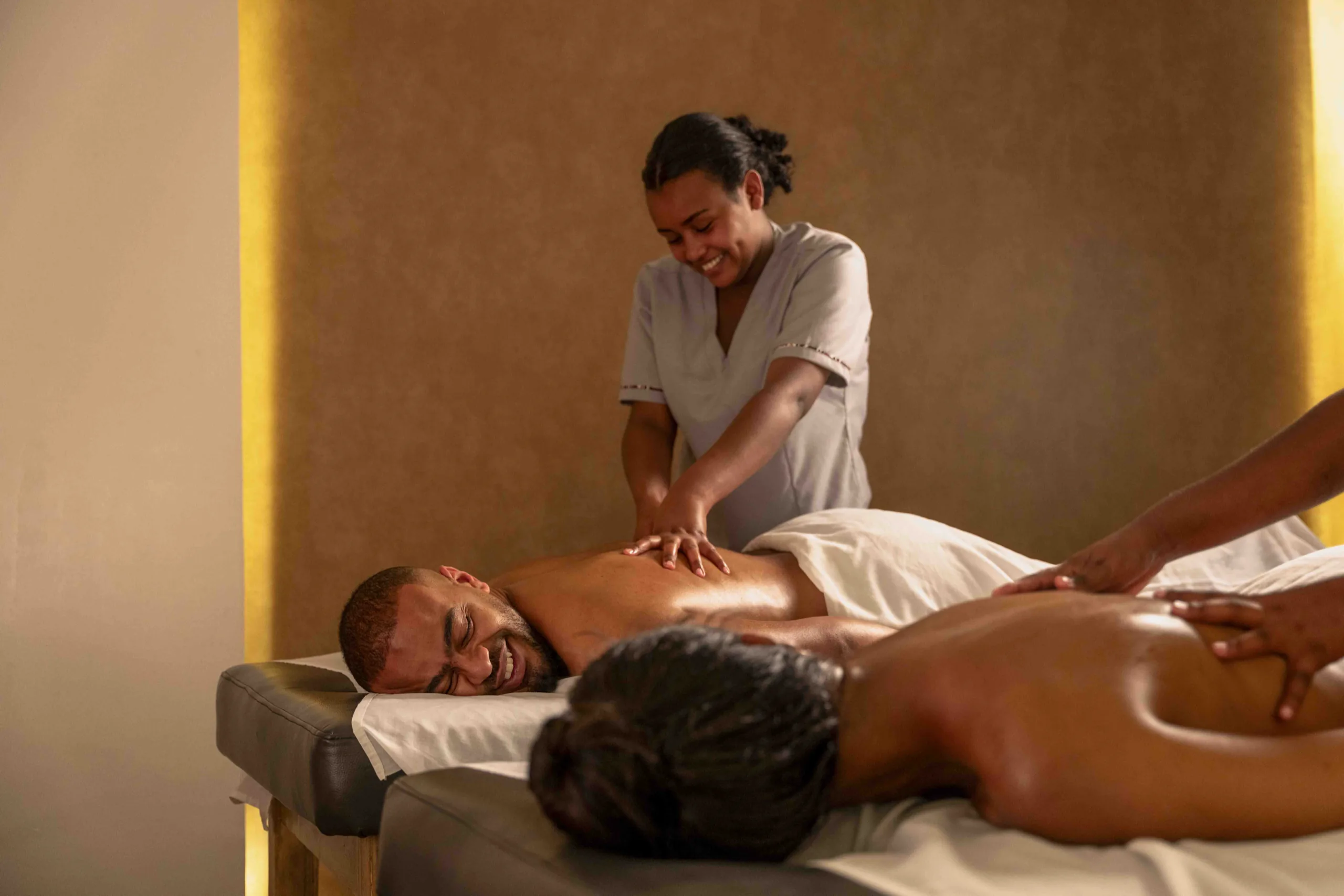 A traveller receiving a massage in a candlelit spa room
