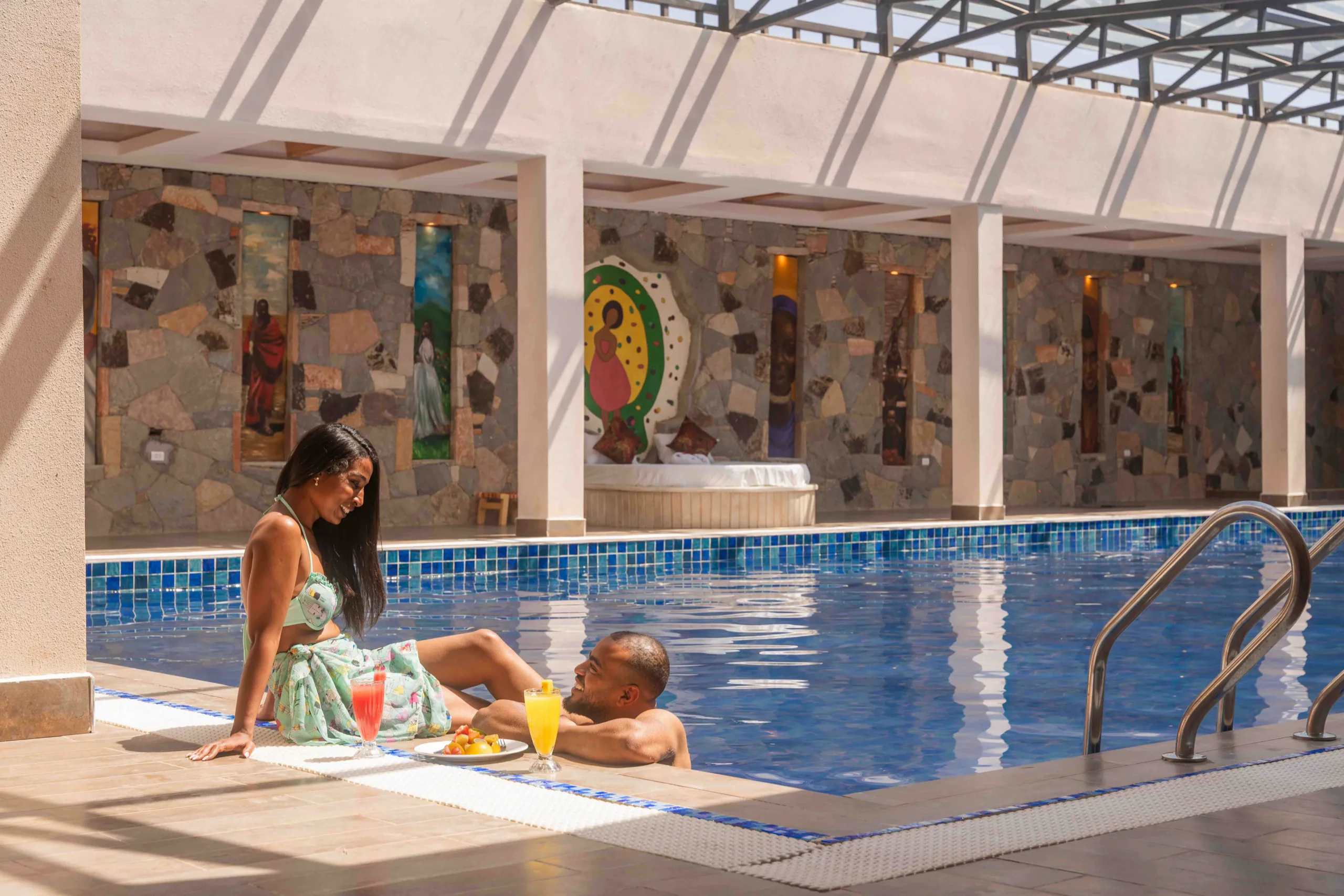 Travellers relaxing beside an indoor pool